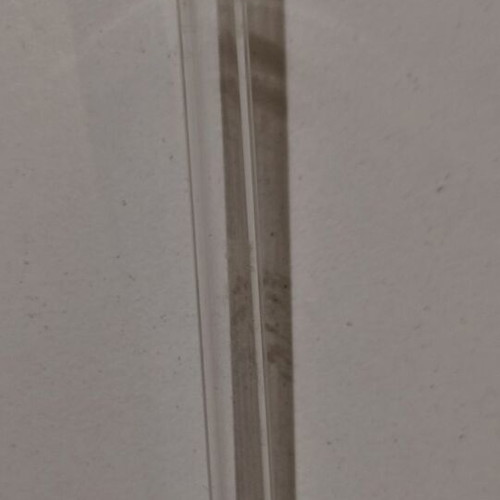 Glass perfume bottle used with golden accents and cap