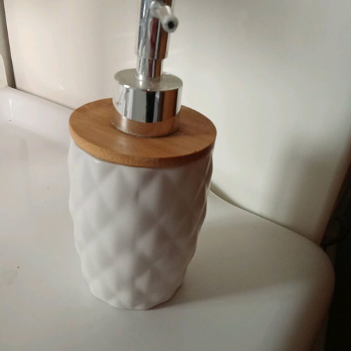 Soap dispenser like new with white ceramic body and bamboo lid