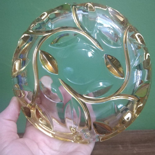Crystal ashtray used, heavy with embossed gold-plated designs
