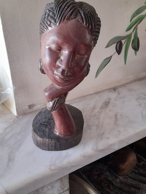 Portrait sculpture carved in red wood used from Kenya