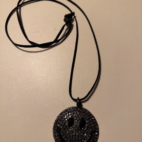 Long pendant like new with decorative emoji and black rhinestones