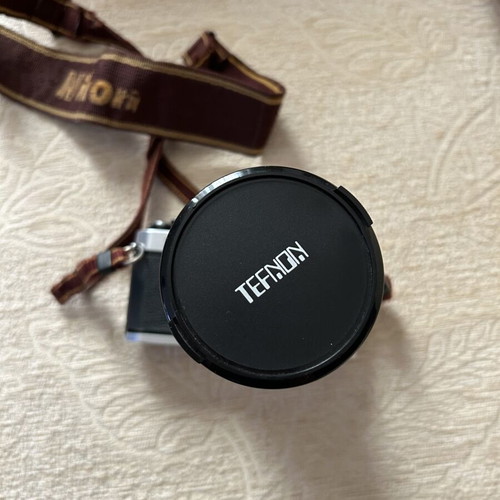 Nikon FM2 35 mm camera used with Telezon telephoto lens and lens cap