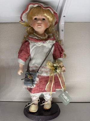 Porcelain doll new with tag and base