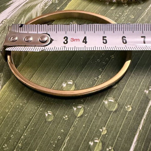 Set of 2 steel bracelets with gold and black details, new