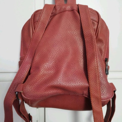 Backpack used red bag with quilted front zipper