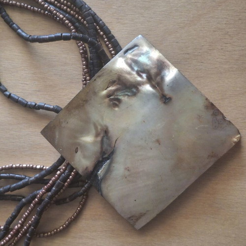 Necklace with large mother-of-pearl plate and beads