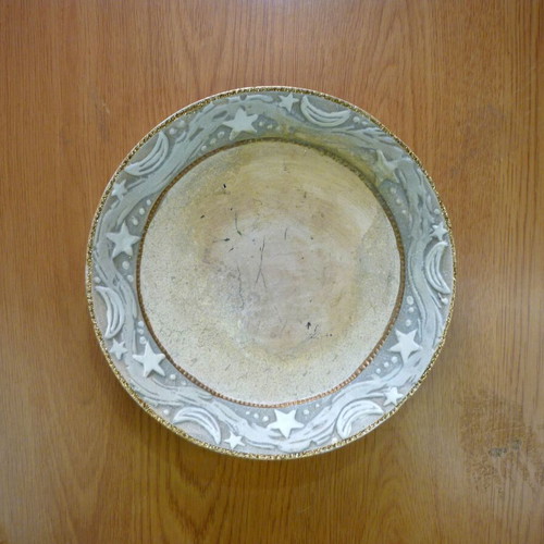 Decorative ceramic plate with embossed stars and moons like new