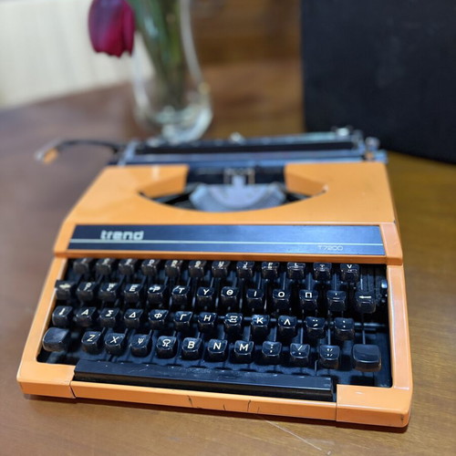 Vintage Trend Typewriter used with ribbon and case, orange color