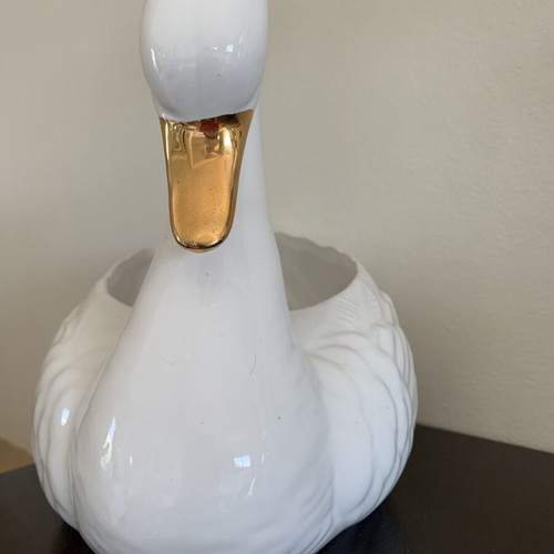 Vintage ceramic swan pair with glossy white finish and gold beak