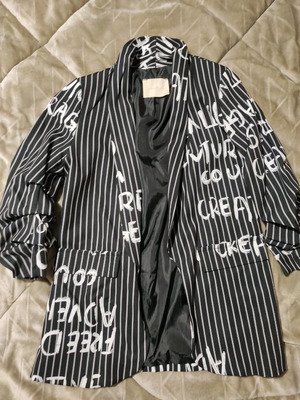 Modern black blazer with stripes and white letters used