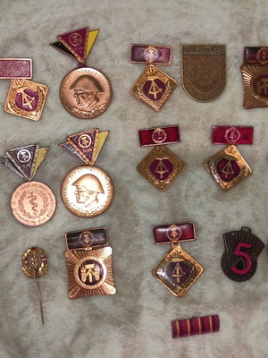 Medals and badges of former East Germany like new, set of 16 pieces