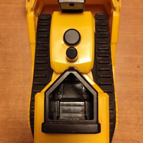 CAT bulldozer toy used with moving tracks and gradual forward-back motion