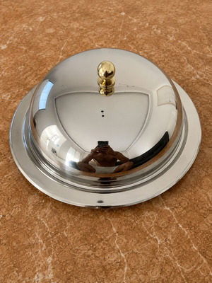 Metal serving bowl with gold handles