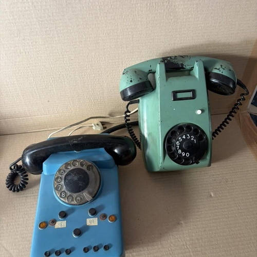 Two wired home phones, green and blue