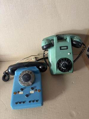 Two wired home phones, green and blue