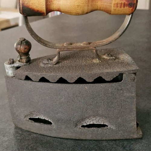 Vintage coal iron used with wooden handle and patina