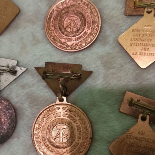 Medals and badges of former East Germany like new, set of 16 pieces