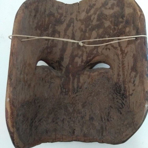 Handmade wooden mask used with aged patina