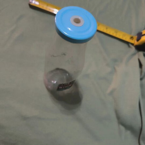 Glass water bottle used with hole for straw