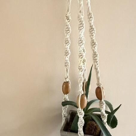 Macrame plant hanger used with wooden beads for pots