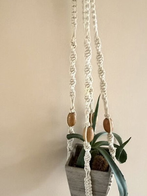 Macrame plant hanger used with wooden beads for pots