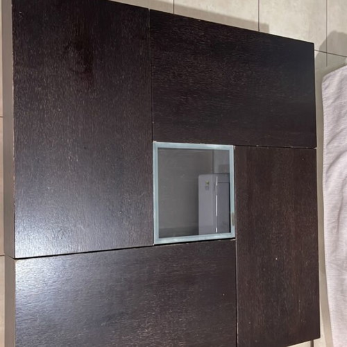 Coffee table made of solid wenge wood with storage and glass center