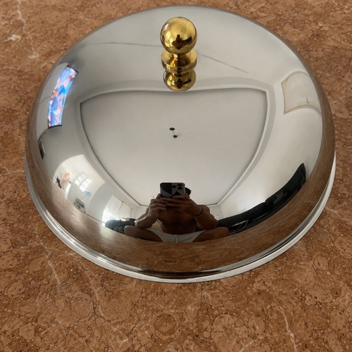 Metal serving bowl with gold handles