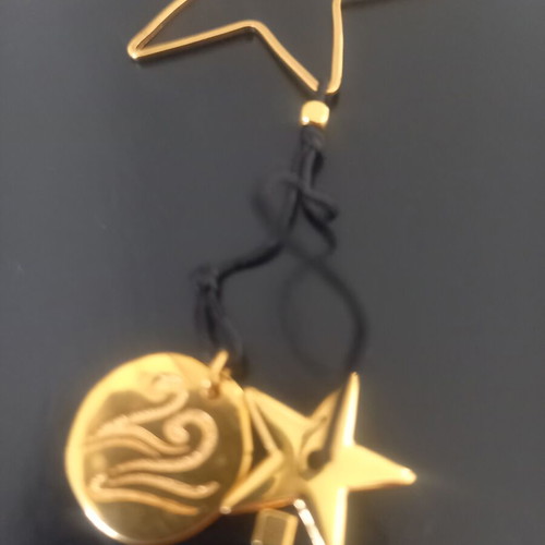 Pendant like new with subtle black and gold details