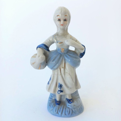 Porcelain figurine used with peasant girl