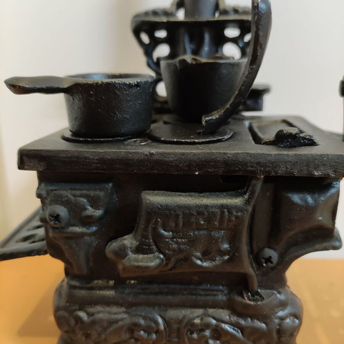 Miniature wooden stove with cast iron accessories like new