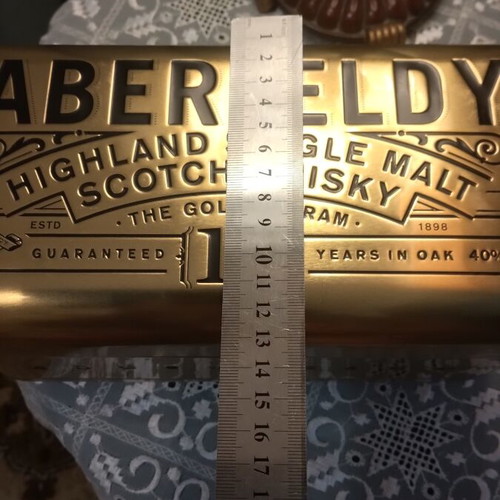 Bottle holder with collectible bottle like new, metal gold color