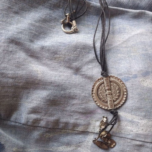 Necklace with steel pendant like new on leather straps