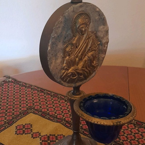 Bronze religious lamp used with embossed Virgin Mary image on stone base