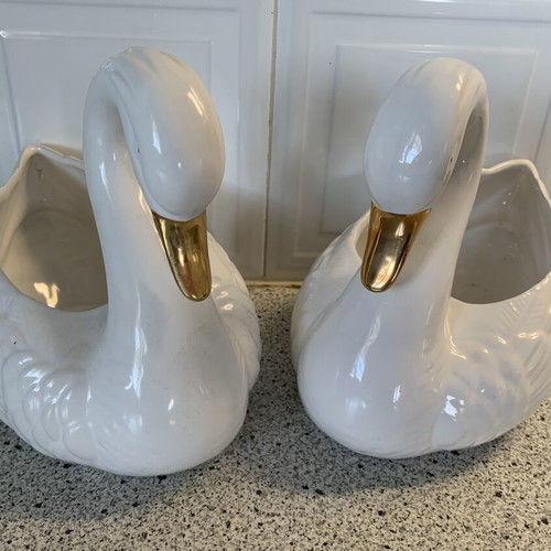 Vintage ceramic swan pair with glossy white finish and gold beak
