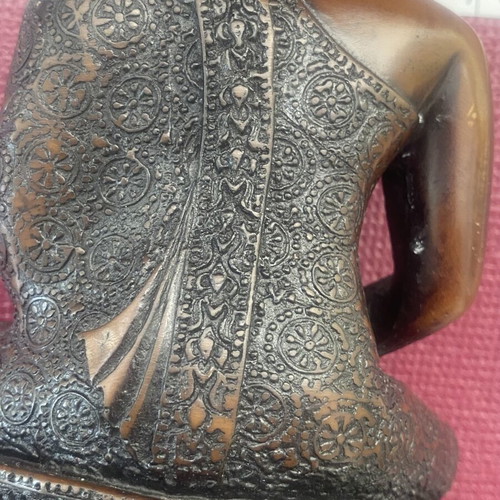 Thai Buddha statue with detailed embossed decoration