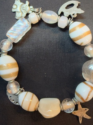 Vintage boho bracelet like new with white glass beads and gold stripes