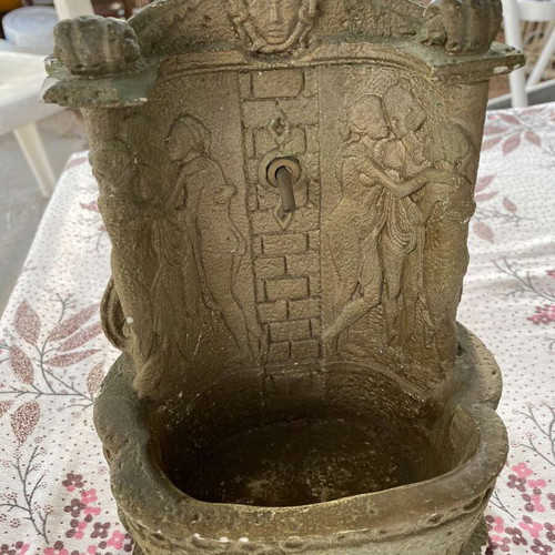 Decorative clay items in gold color, including Gorgoneion