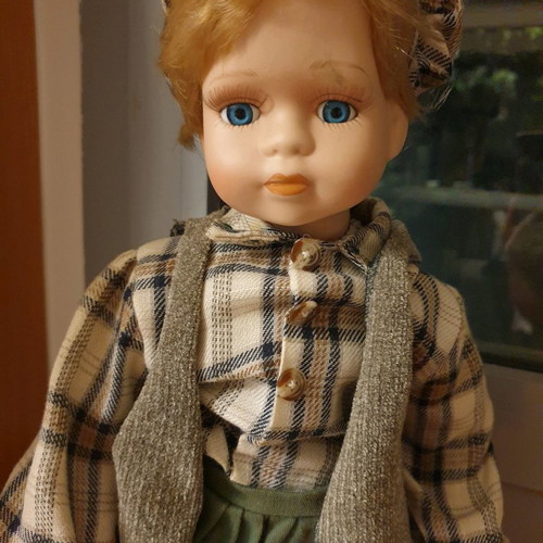 Porcelain dolls new with handmade clothes and support base