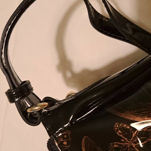 Hexagona black patent leather shoulder bag with gold butterfly pattern