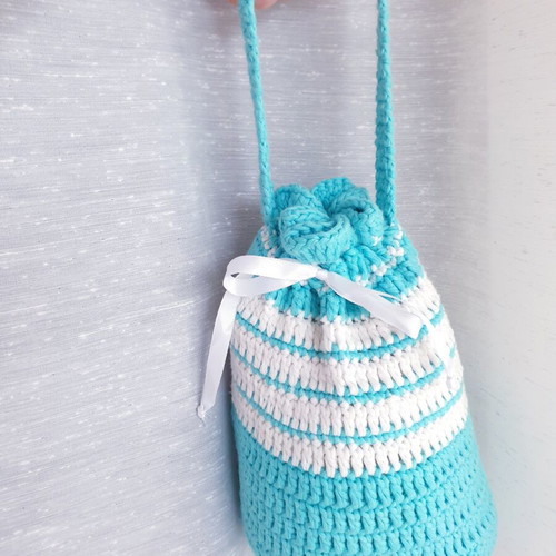 Handmade turquoise knitted pouch toiletry bag used