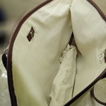 Large beige fabric shoulder bag with brown leather details