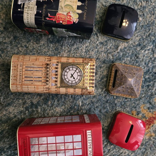 Set of three tin piggy banks like new from England
