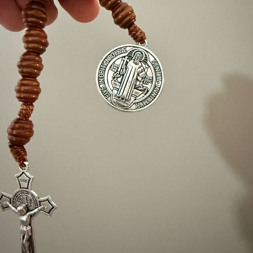 Religious bracelet with wooden beads, cross pendant, and Saint Benedict medal