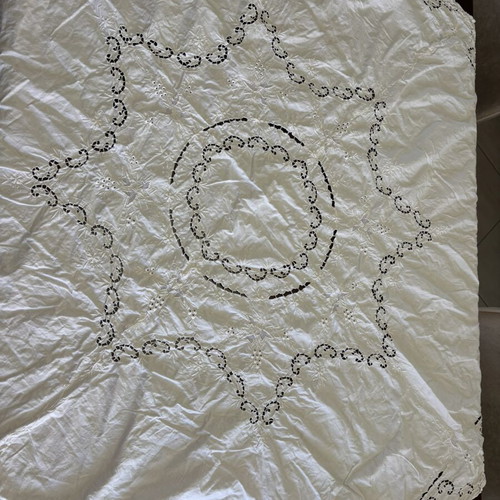 Handmade tablecloth used, cotton fabric with intricate cutwork embroidery