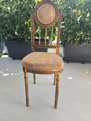 Handmade antique chair with fabric and carved wood