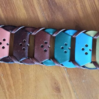 Colorful woven belt in warm shades made of faux leather, like new
