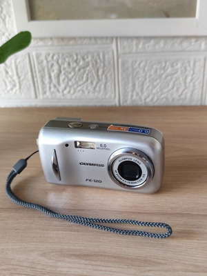Olympus FE-120 digital camera used with leather case