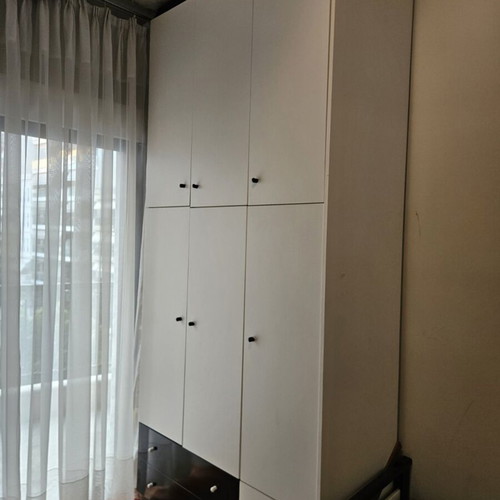 Bedroom wardrobe used with storage spaces, modern design, white doors