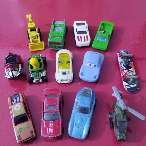 Set of various toy cars used, including helicopters and bulldozer