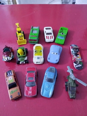Set of various toy cars used, including helicopters and bulldozer